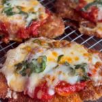 Classic crispy chicken parmesan with melted cheese and marinara