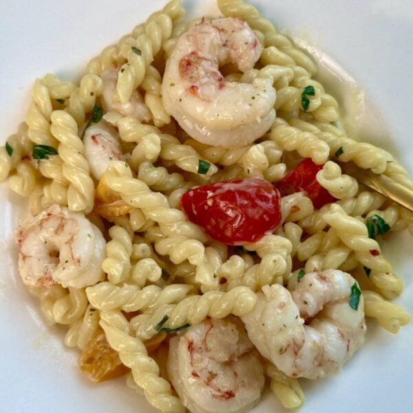 Garlic shrimp tossed with twisted pasta, cherry tomatoes and fresh herbs