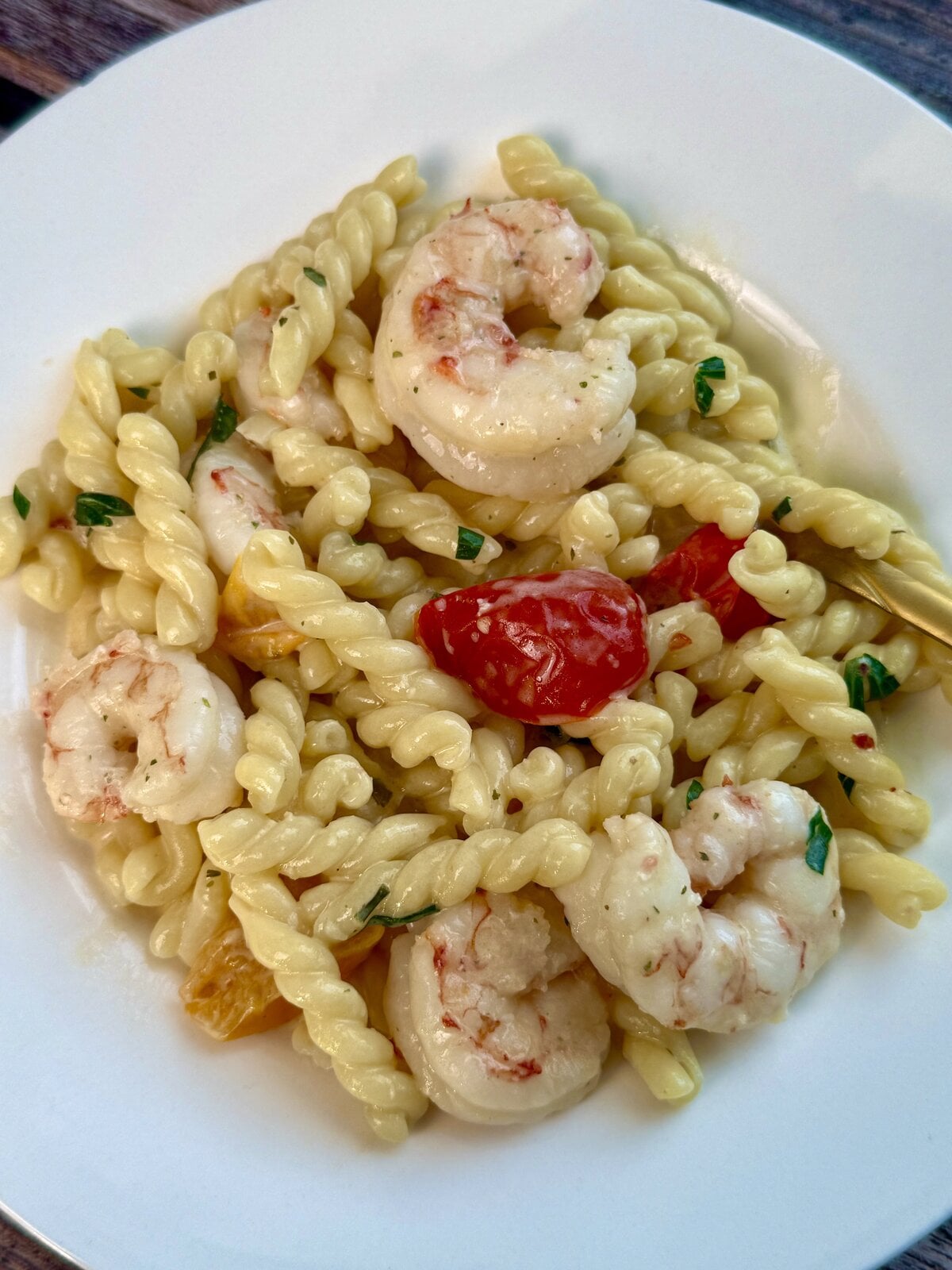 Garlic shrimp tossed with twisted pasta, cherry tomatoes and fresh herbs