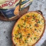 Creamy cheesy scalloped potatoes layered in a baking dish