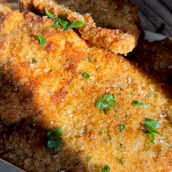 Golden breaded chicken cutlets sprinkled with fresh chopped parsley