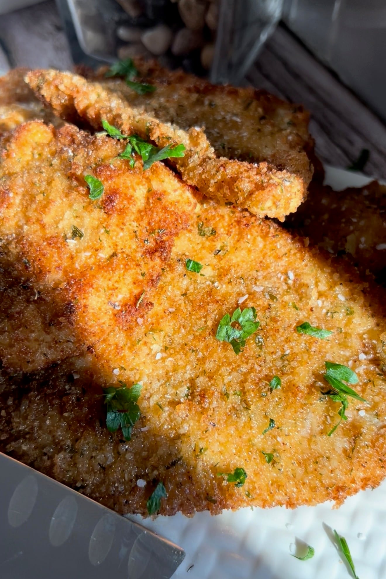 Golden breaded chicken cutlets sprinkled with fresh chopped parsley