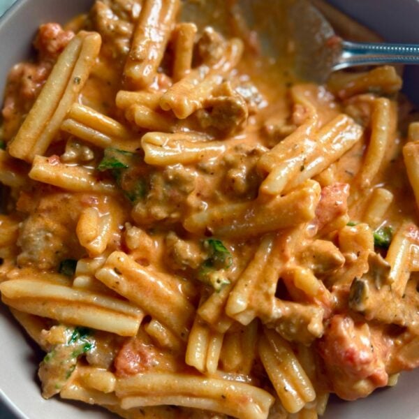 Casarecce pasta in creamy tomato sauce with Italian sausage and fresh parsley