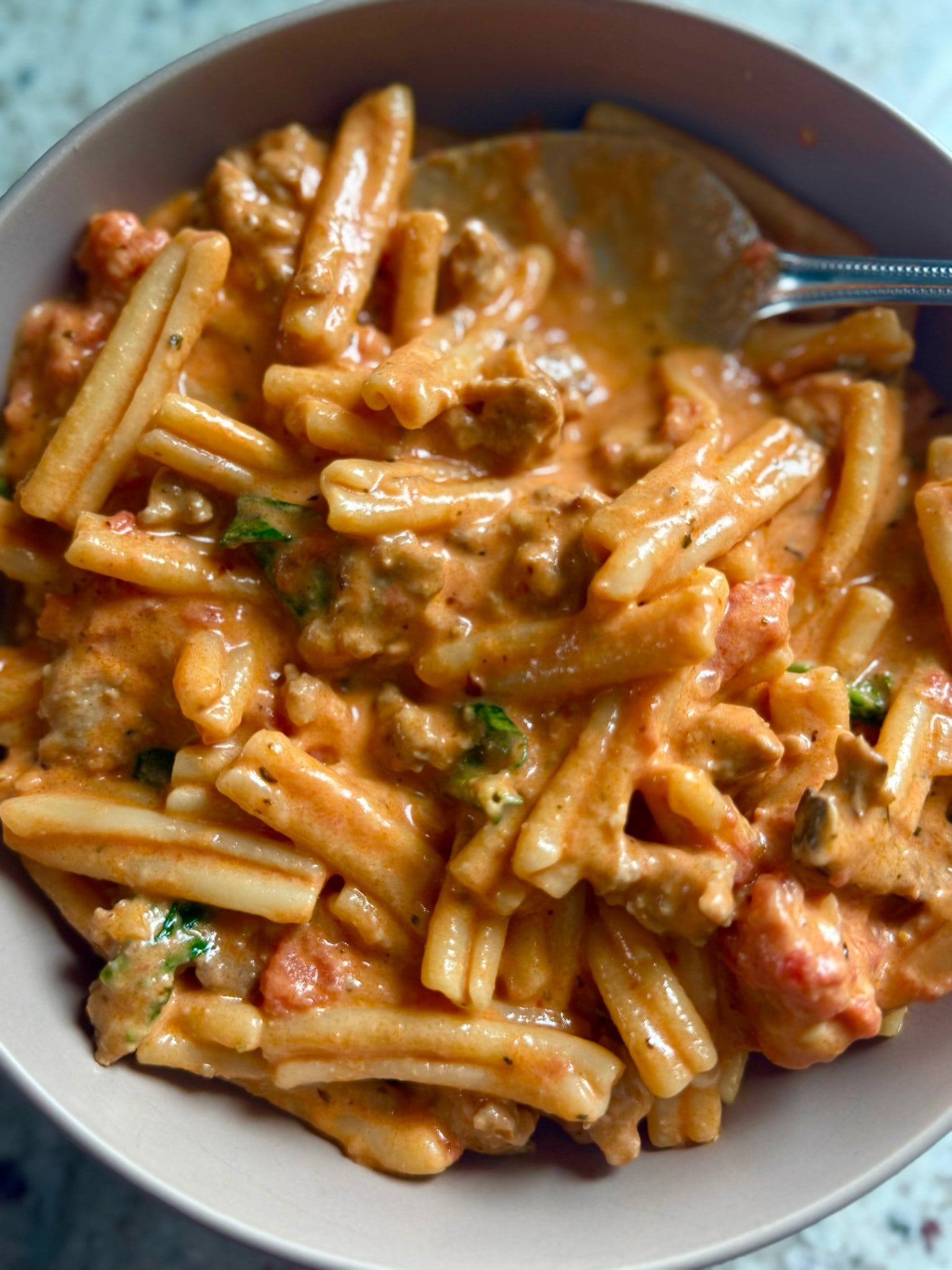 Casarecce pasta in creamy tomato sauce with Italian sausage and fresh parsley