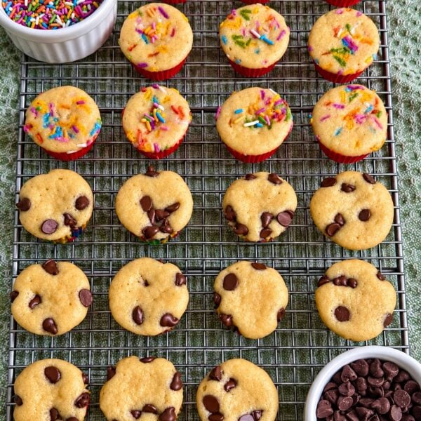 Cooling rack of confetti and chocolate chip mini muffins beside bowls of sprinkles