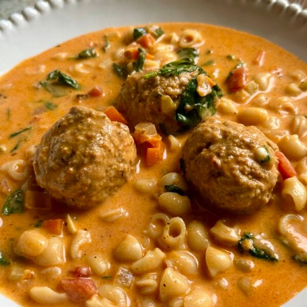 Meatballs, small shells and spinach in a creamy tomato soup