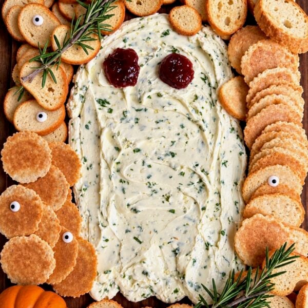 Ghost-shaped herbed whipped butter board ringed by crostini, rosemary and a mini pumpkin