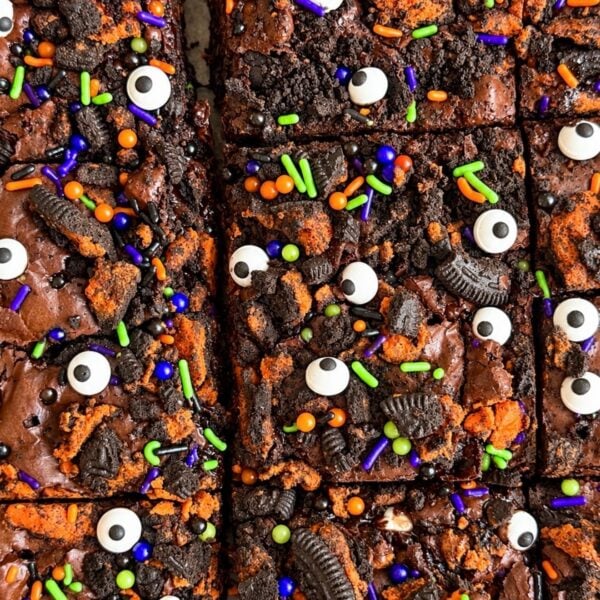 Halloween Oreo brownies topped with candy eyes and orange and purple sprinkles
