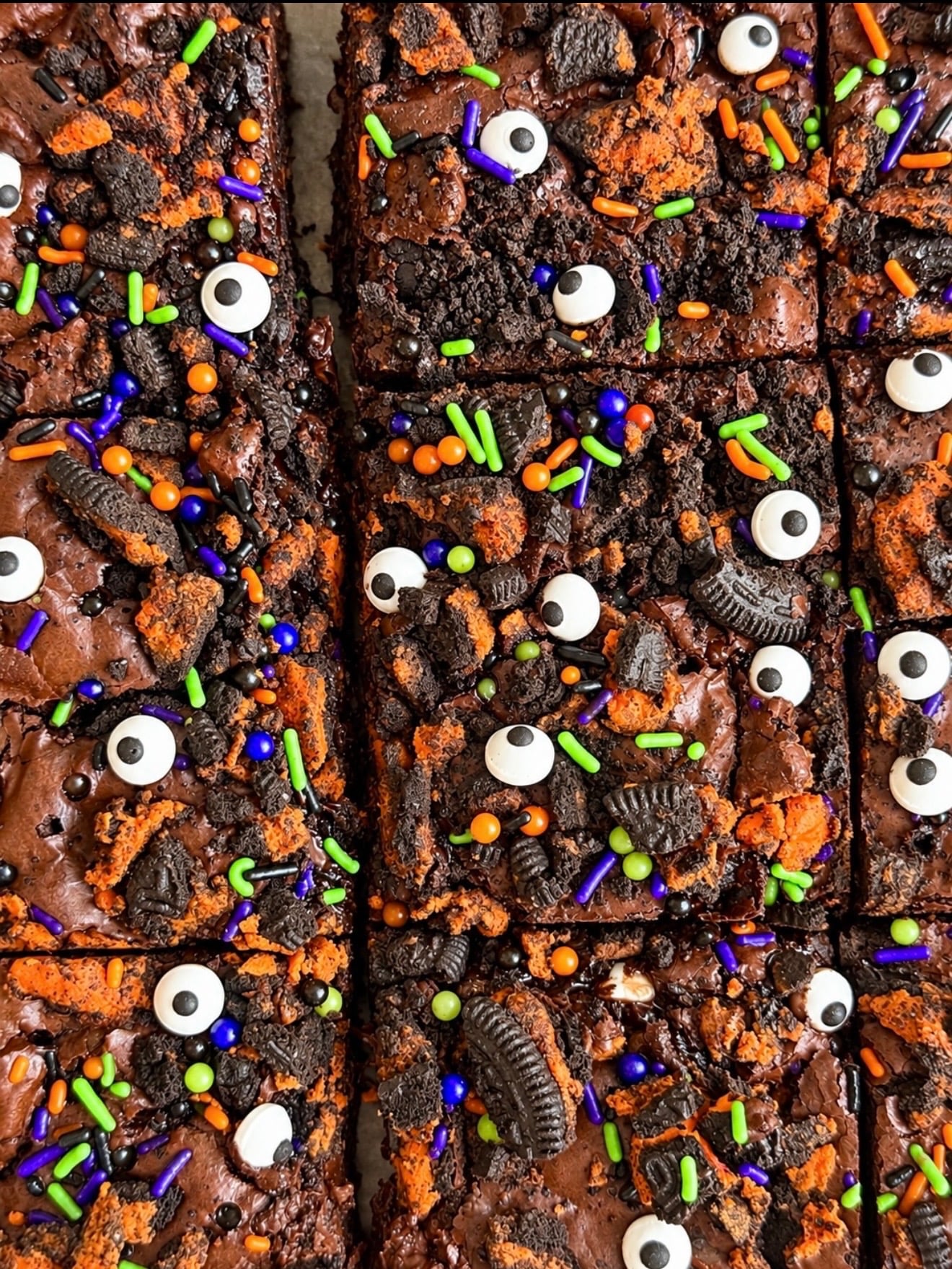 Halloween Oreo brownies topped with candy eyes and orange and purple sprinkles