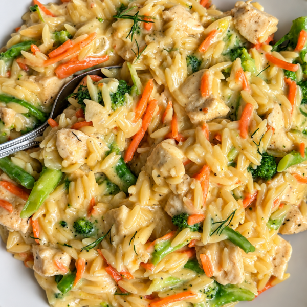 Orzo with chicken, broccoli and shredded carrot in a creamy cheddar sauce