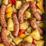 Sheet pan of roasted Italian sausages with golden potatoes, peppers and onions