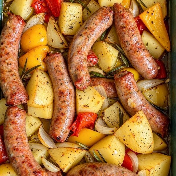 Sheet pan of roasted Italian sausages with golden potatoes, peppers and onions