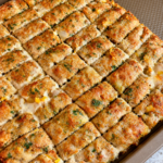 Sheet pan of golden turkey kebab strips flecked with herbs, fresh from the oven